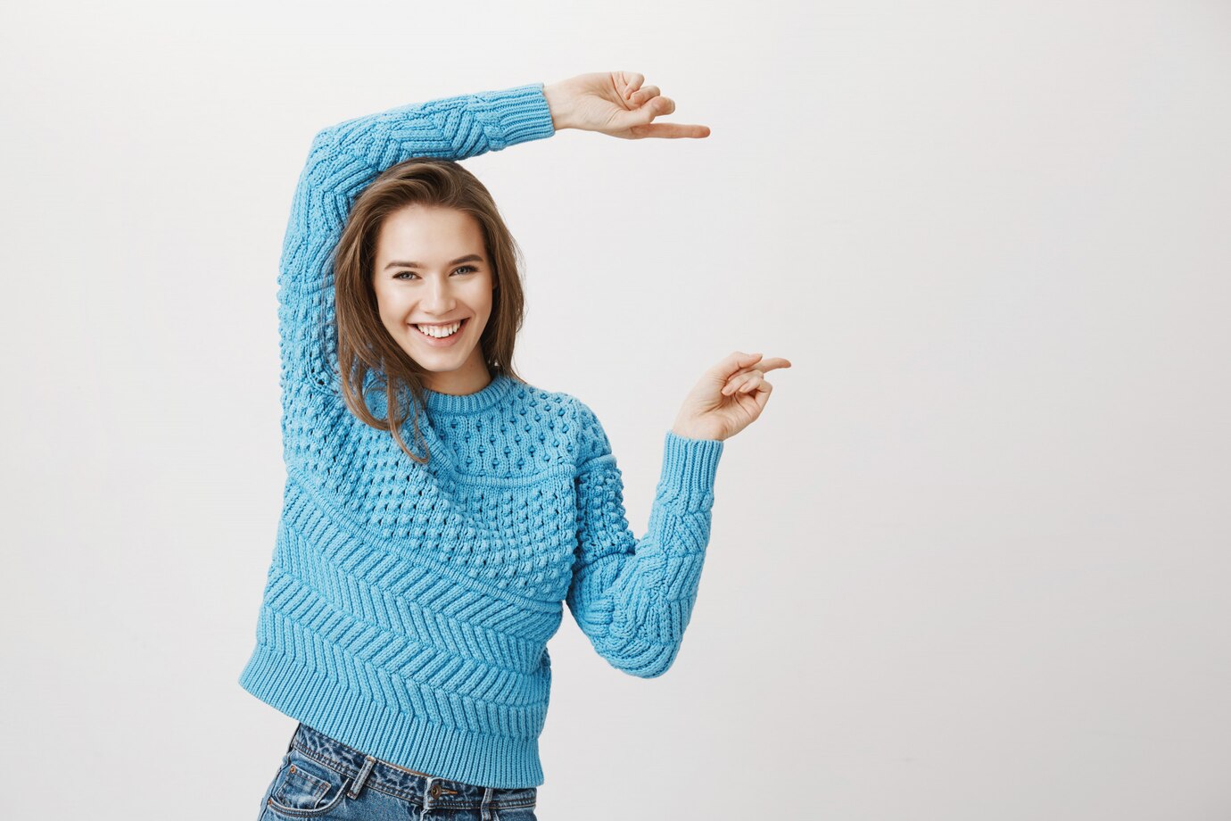attractive-smiling-happy-woman-pointing-fingers-right_176420-17747