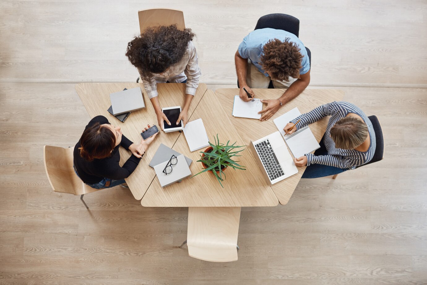 view-from-business-startup-teamwork-concept-startup-partners-sitting-coworking-space-talking-about-future-project-looking-through-examples-work-laptop-digital-tablet_176420-8330